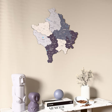 Nimbus Kosovo wooden wall map on a beige wall above a console with figurines
