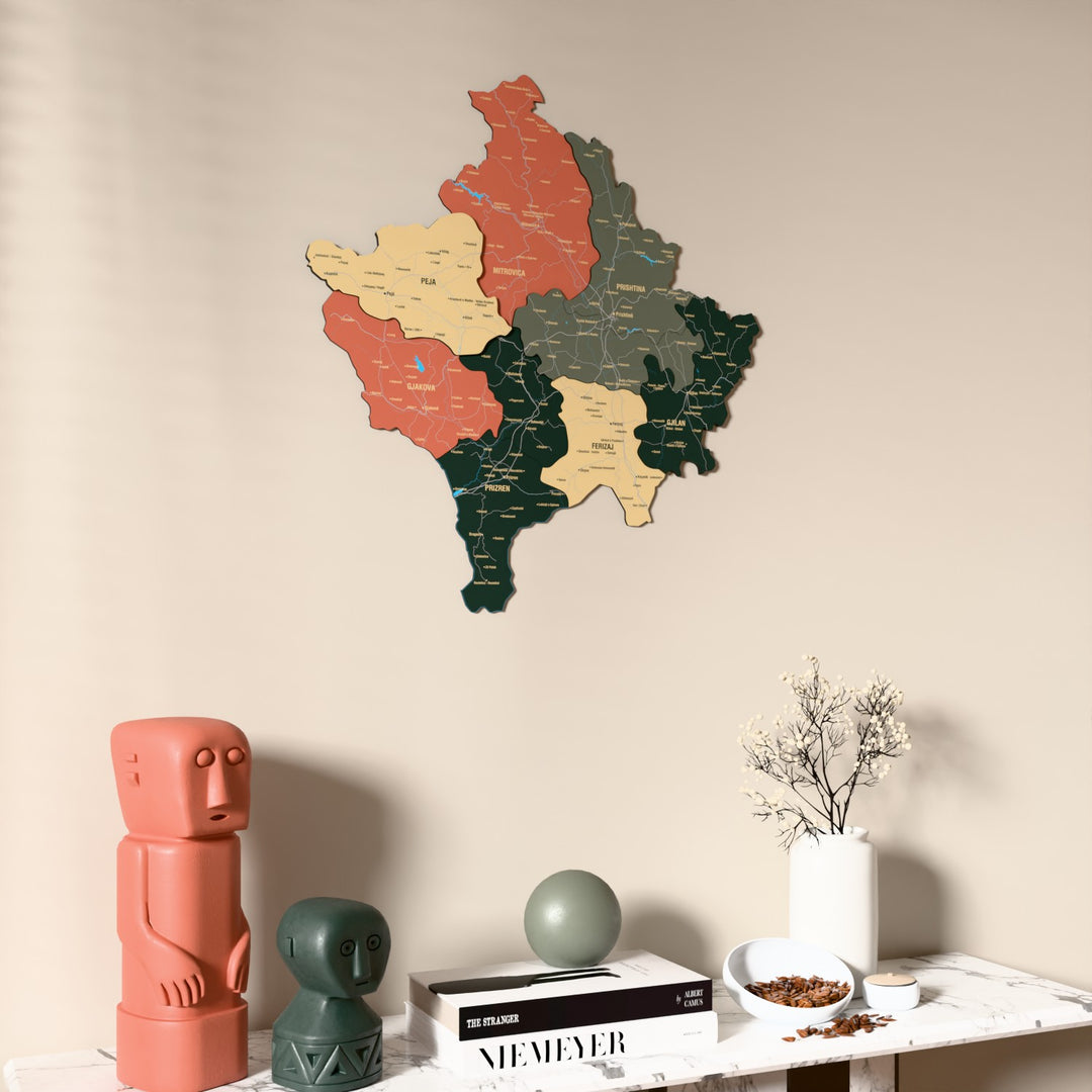 Sage Kosovo wooden wall map on a beige wall above a console with figurines