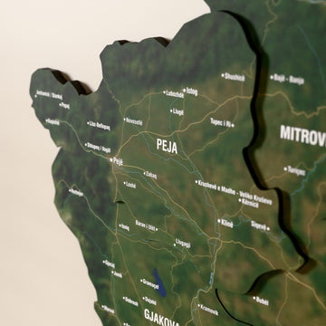 Close-up of the Satellite Kosovo wooden wall map with layered regions and printed names