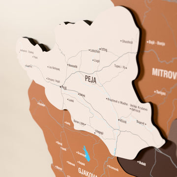 Close-up of the Soil Kosovo wooden wall map with layered regions and printed names