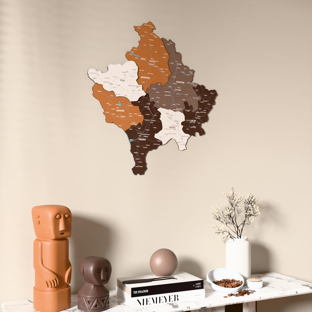 Soil Kosovo wooden wall map on a beige wall above a console with figurines