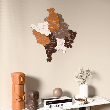 Soil Kosovo wooden wall map on a beige wall above a console with figurines