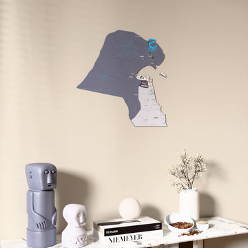 Nimbus Kuwait wooden wall map on a beige wall above a console with figurines