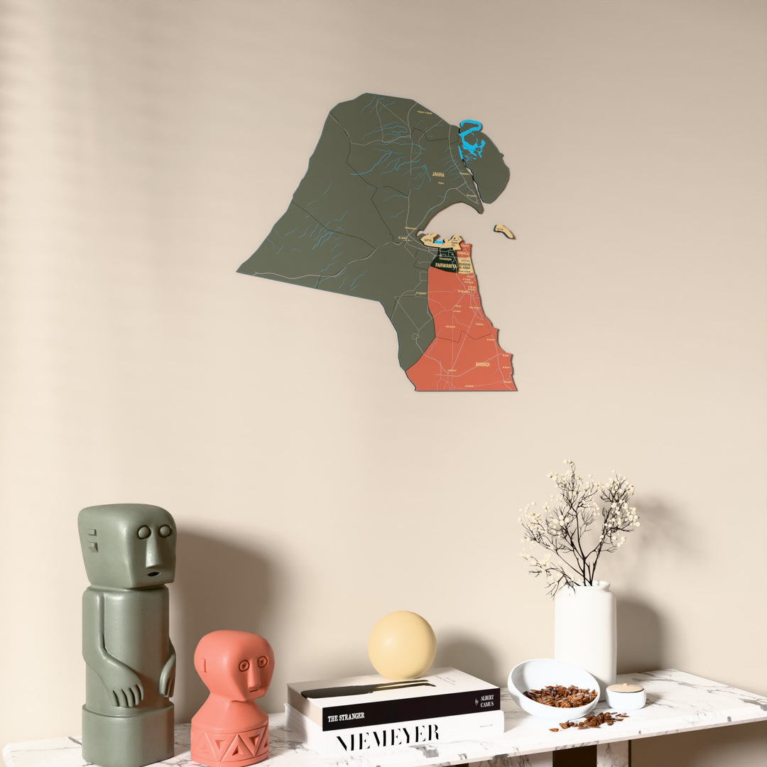 Sage Kuwait wooden wall map on a beige wall above a console with figurines