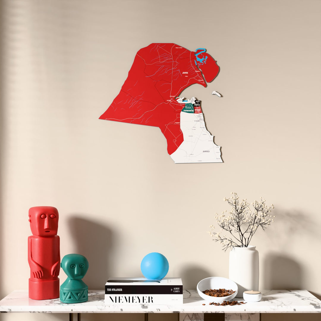 Flag colored Kuwait wooden wall map above a marble console, front view