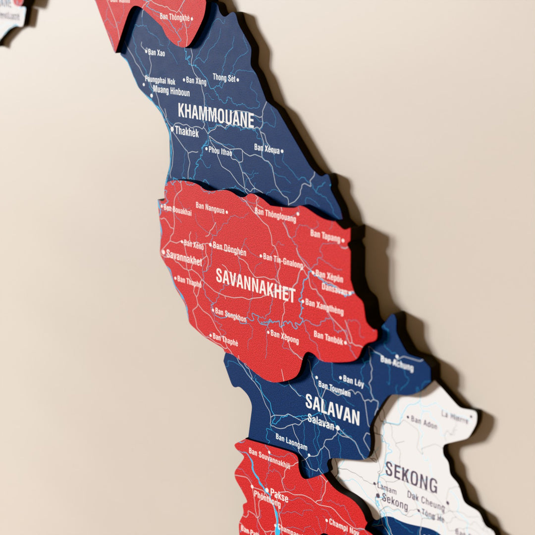 Close-up of the Flag colored Laos wooden wall map with layered regions and printed names