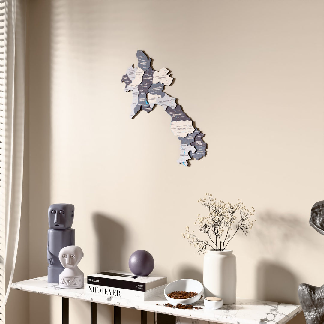 Nimbus Laos wooden wall map beside a sheer curtain, angled view