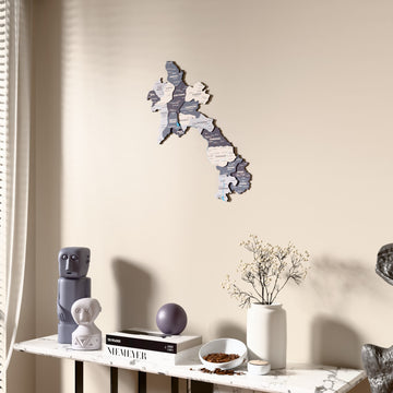 Nimbus Laos wooden wall map beside a sheer curtain, angled view