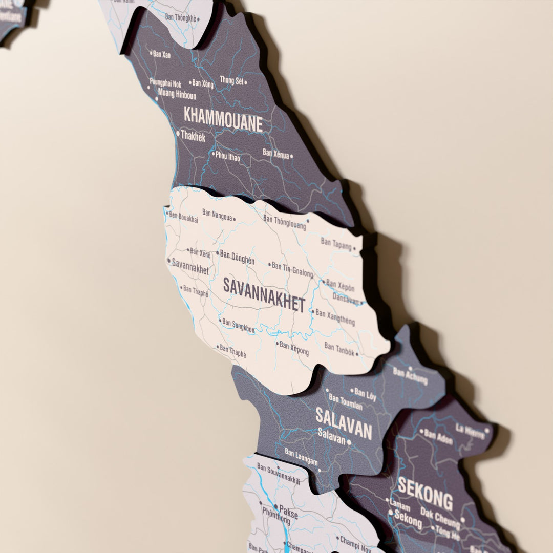 Close-up of the Nimbus Laos wooden wall map with layered regions and printed names