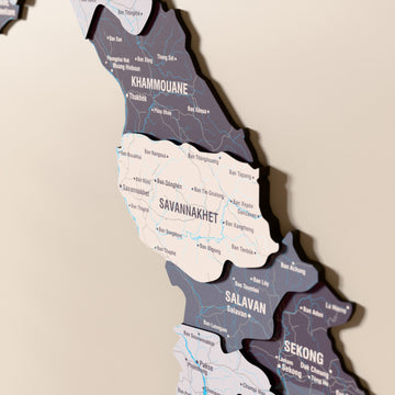 Close-up of the Nimbus Laos wooden wall map with layered regions and printed names