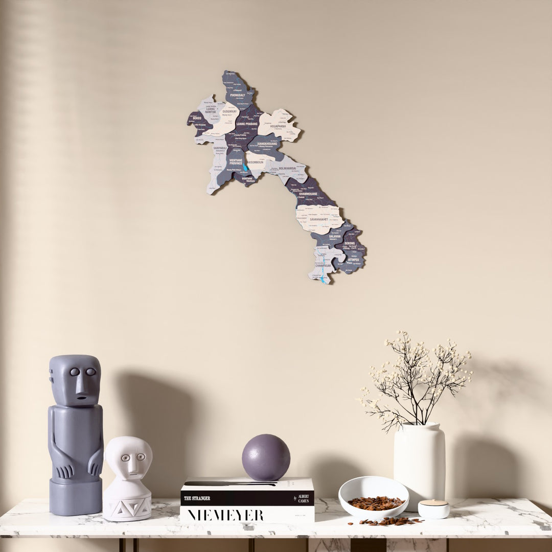 Nimbus Laos wooden wall map above a marble console, front view