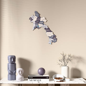 Nimbus Laos wooden wall map above a marble console, front view