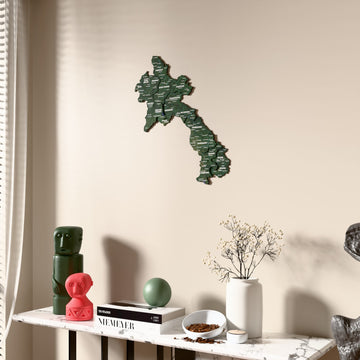 Satellite Laos wooden wall map beside a sheer curtain, angled view
