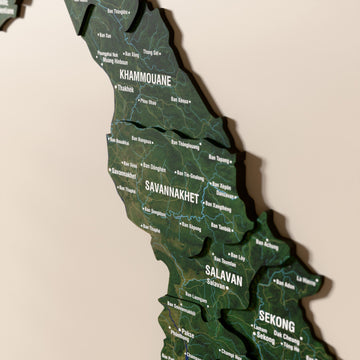 Close-up of the Satellite Laos wooden wall map with layered regions and printed names