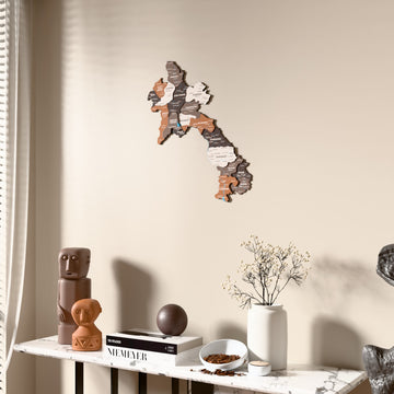 Soil Laos wooden wall map beside a sheer curtain, angled view