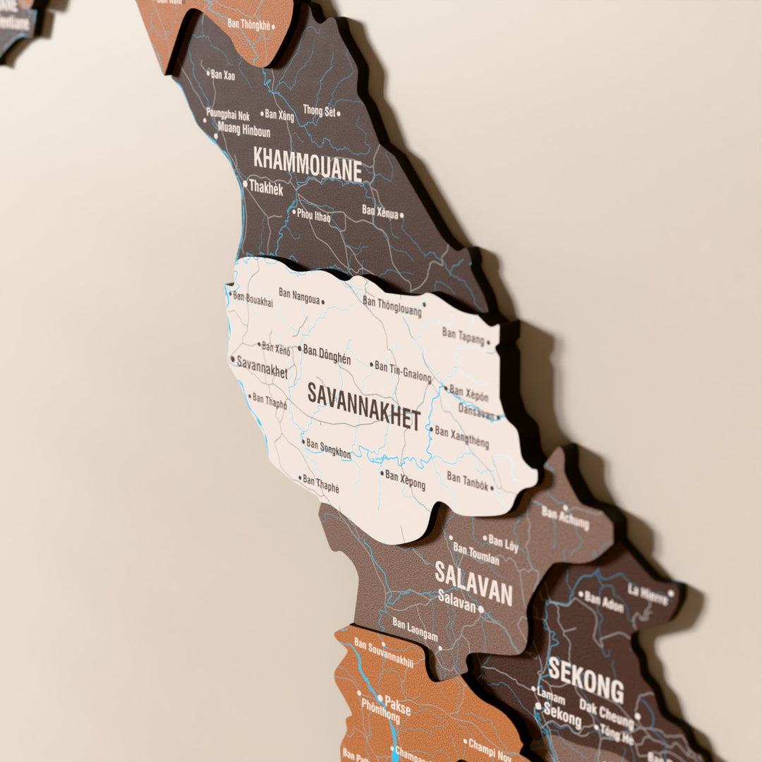Close-up of the Soil Laos wooden wall map with layered regions and printed names