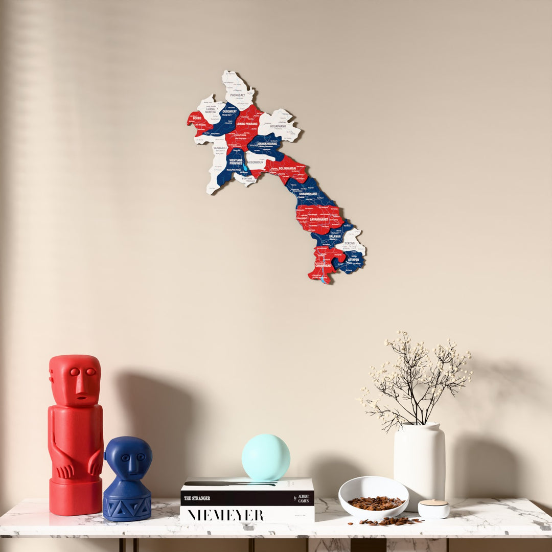 Flag colored Laos wooden wall map above a marble console, front view