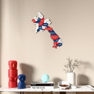 Flag colored Laos wooden wall map above a marble console, front view