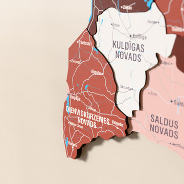 Close-up of the Flag colored Latvia wooden wall map with layered regions and printed names