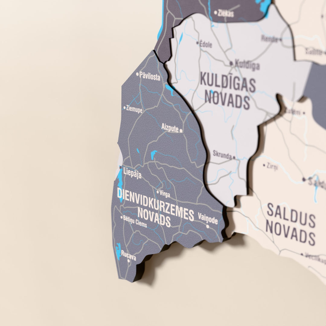 Close-up of the Nimbus Latvia wooden wall map with layered regions and printed names