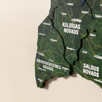 Close-up of the Satellite Latvia wooden wall map with layered regions and printed names