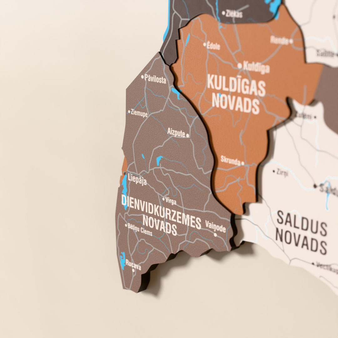 Close-up of the Soil Latvia wooden wall map with layered regions and printed names