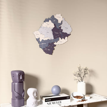 Nimbus Lesotho wooden wall map on a beige wall above a console with figurines