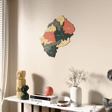 Sage Lesotho wooden wall map beside a sheer curtain, angled view