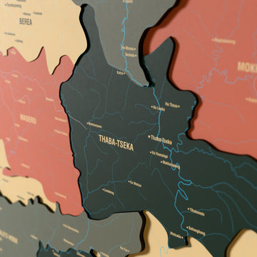 Close-up of the Sage Lesotho wooden wall map with layered regions and printed names