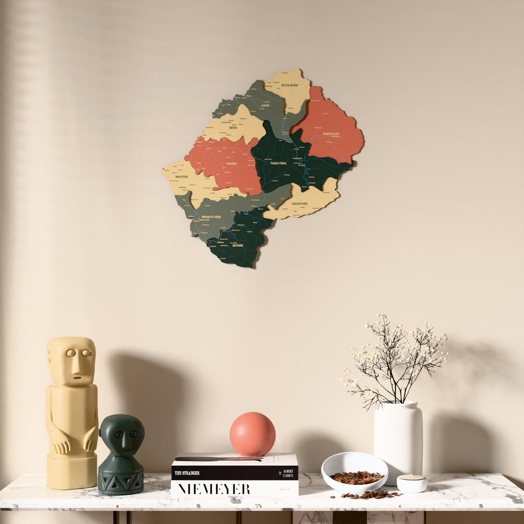 Sage Lesotho wooden wall map above a marble console, front view
