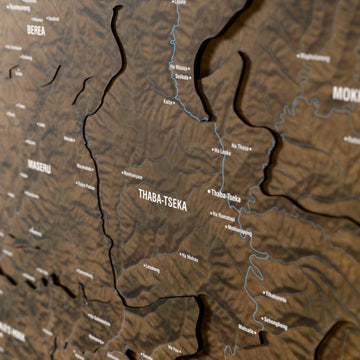 Close-up of the Satellite Lesotho wooden wall map with layered regions and printed names