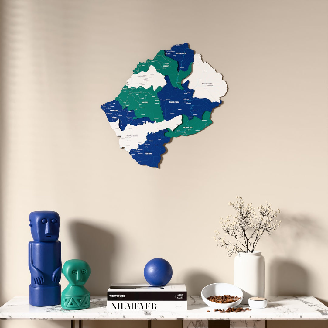 Flag colored Lesotho wooden wall map above a marble console, front view