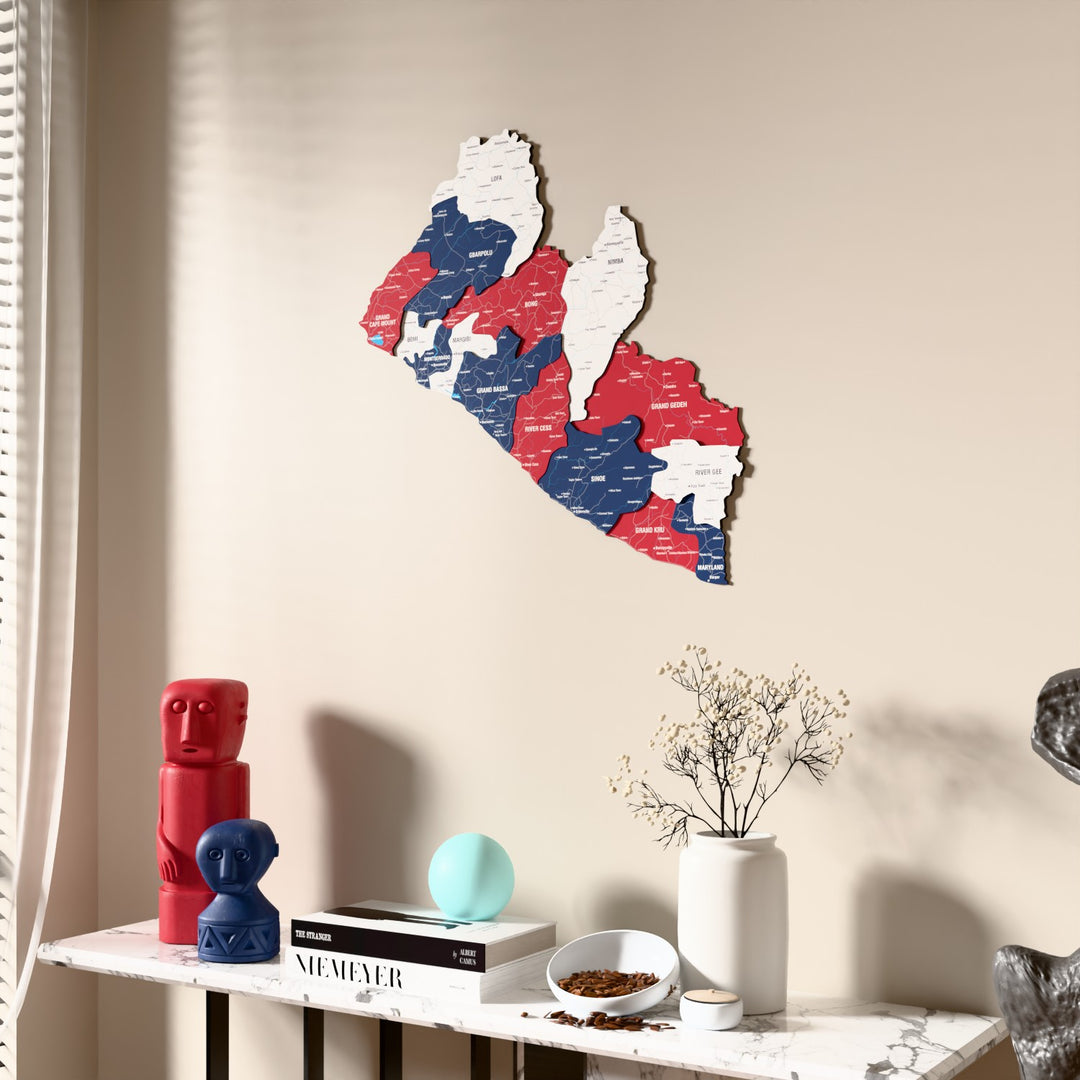 Flag colored Liberia wooden wall map beside a sheer curtain, angled view