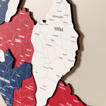 Close-up of the Flag colored Liberia wooden wall map with layered regions and printed names