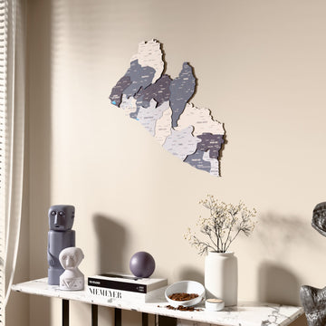 Nimbus Liberia wooden wall map beside a sheer curtain, angled view