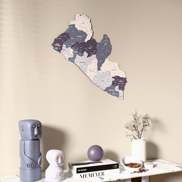 Nimbus Liberia wooden wall map on a beige wall above a console with figurines
