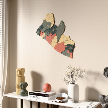 Sage Liberia wooden wall map beside a sheer curtain, angled view