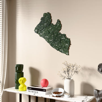 Satellite Liberia wooden wall map beside a sheer curtain, angled view