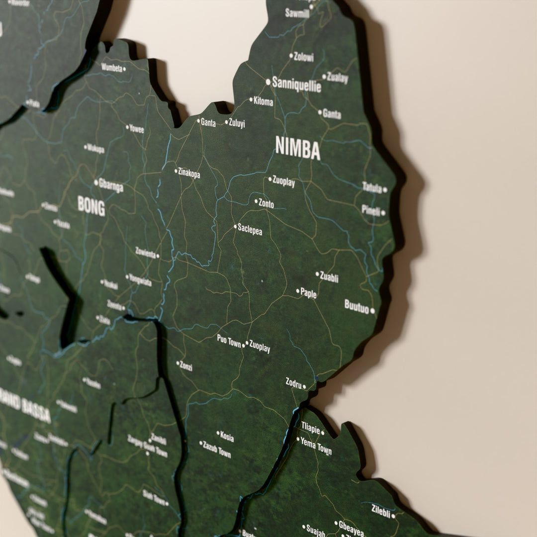 Close-up of the Satellite Liberia wooden wall map with layered regions and printed names