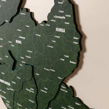 Close-up of the Satellite Liberia wooden wall map with layered regions and printed names