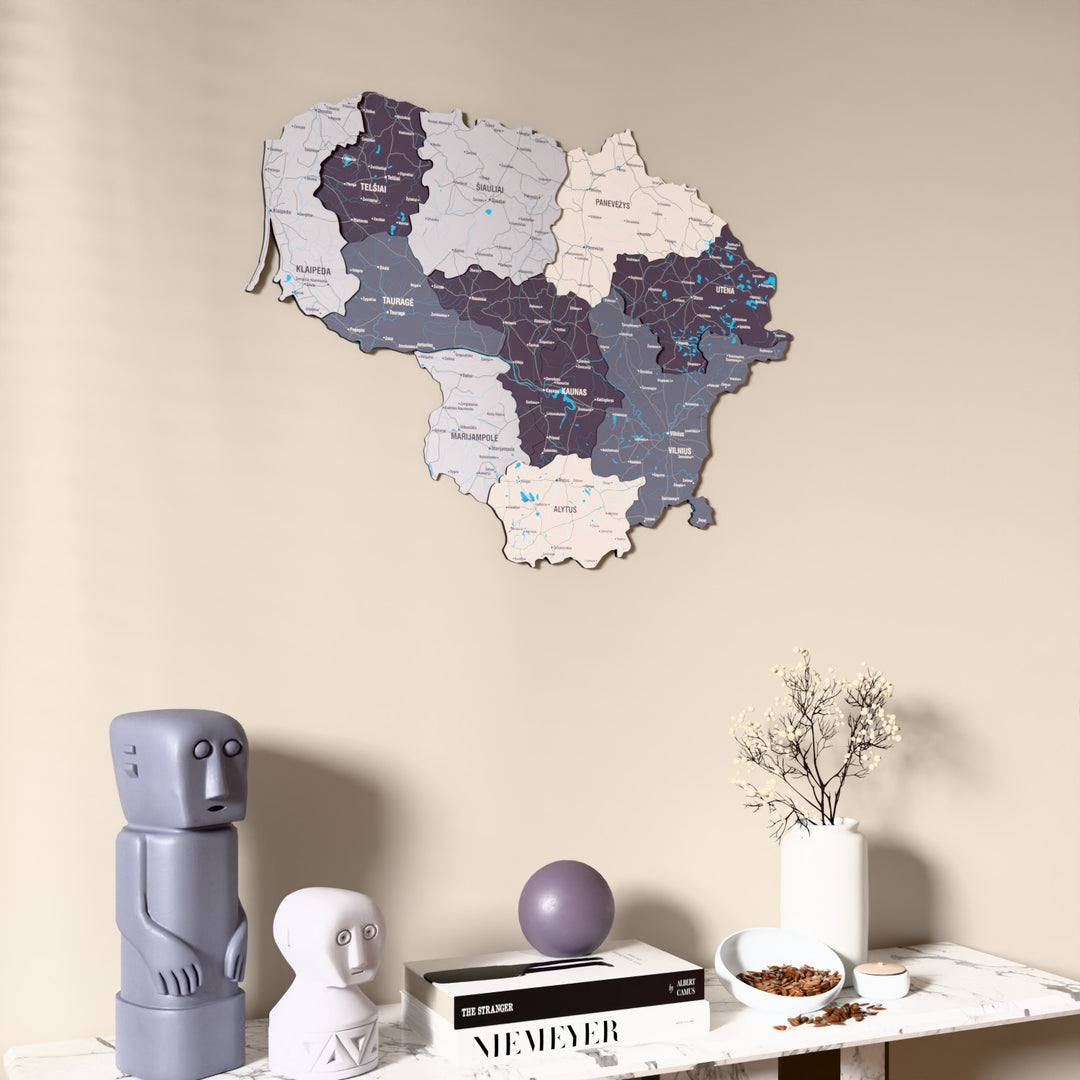 Nimbus Lithuania wooden wall map on a beige wall above a console with figurines