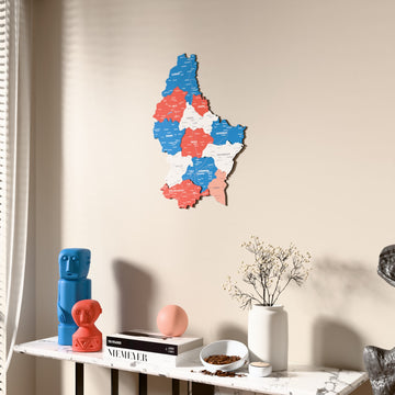 Flag colored Luxembourg wooden wall map beside a sheer curtain, angled view