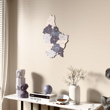 Nimbus Luxembourg wooden wall map beside a sheer curtain, angled view