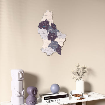 Nimbus Luxembourg wooden wall map on a beige wall above a console with figurines