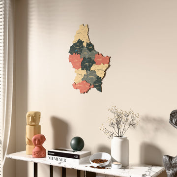 Sage Luxembourg wooden wall map beside a sheer curtain, angled view