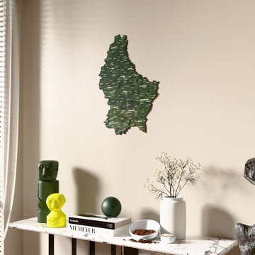 Satellite Luxembourg wooden wall map beside a sheer curtain, angled view