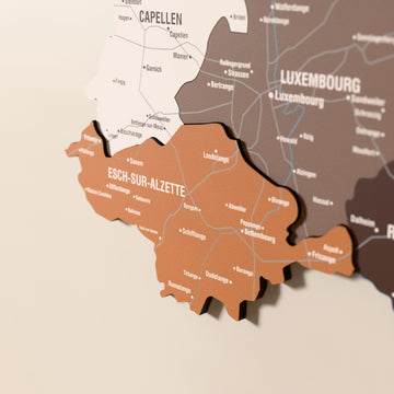 Close-up of the Soil Luxembourg wooden wall map with layered regions and printed names