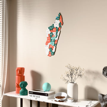 Flag colored Madagascar wooden wall map beside a sheer curtain, angled view