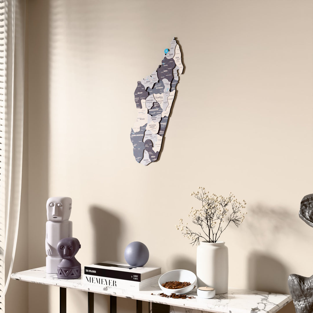 Nimbus Madagascar wooden wall map beside a sheer curtain, angled view