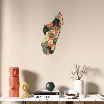 Sage Madagascar wooden wall map above a marble console, front view